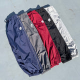 N logo side-zip nylon pants